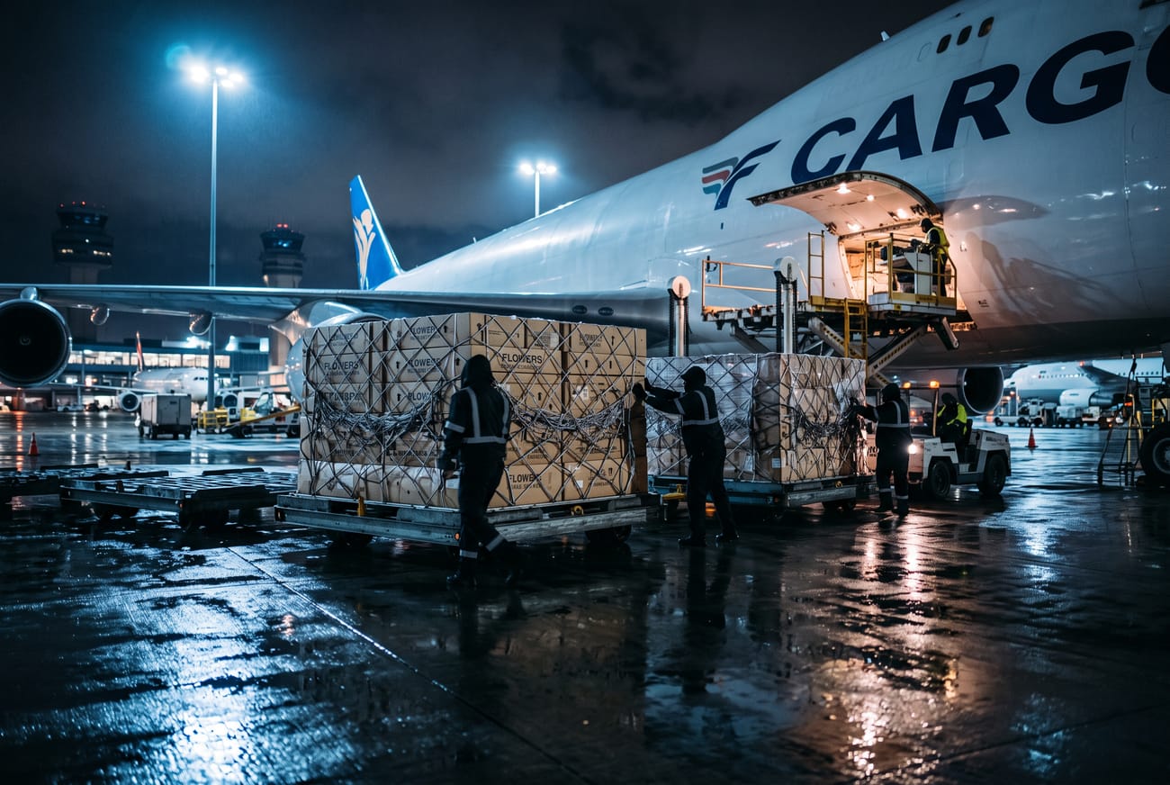 Flower boxes loaded onto a freighter aircraft at night